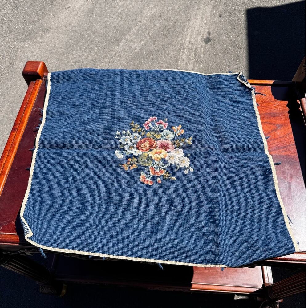 vintage hand-stitched needlepoint canvas tapestry floral bouquet blue background